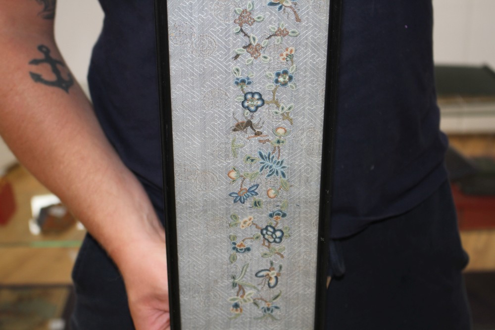 A Chinese silkwork double sleeve panel, 77 x 18cm overall, a smaller floral panel, 61 x 11cm and another, 34 x 26cm overall